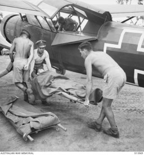 An ambulance plane brings back wounded from Kokoda. The wounded man is Private. J. W. Clont of NSW. The pilot of the plane is Staff Sergeant N. D. Maxwell of Claire, Michigan