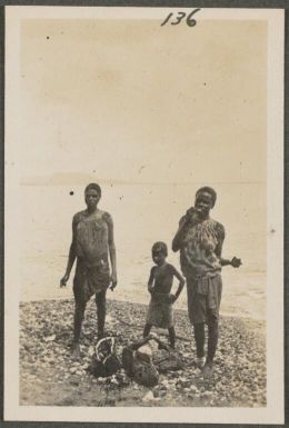 Two Tolai girls and a boy on a beach, New Britain Island, Papua New Guinea, probably 1916