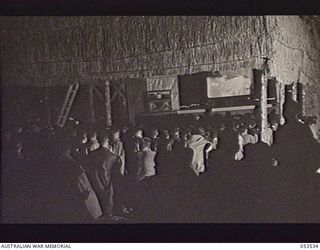SOGERI VALLEY, NEW GUINEA, 1943-06-27. NEW GUINEA FORCE SCHOOL OF SIGNALS THEATRE, WHICH WAS BUILT BY MEMBERS OF THE STAFF DURING OFF DUTY HOURS. IT HAS A SEATING CAPACITY OF 400. THE THEATRE IS ..