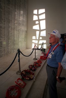 USS ARIZONA crew member Frances M. Falge gazes at USS ARIZONA Memorial wall engraved with the names of his shipmates who perished during Dec. 7, 1941, attack on Pearl Harbor. He and other USS ARIZONA survivors are on a private tour of the memorial following 50th anniversary Remembrance Day ceremonies