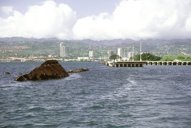 A view of the wreck of the former battleship-target ship USS UTAH (BB-31, AG-16), which was sunk at its moorings on the west side of Ford Island on December 7, 1941, during the Japanese attack on Pearl Harbor