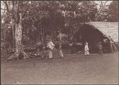 Children gathered near building in the village of Tegua, Torres Islands, 1906 / J.W. Beattie