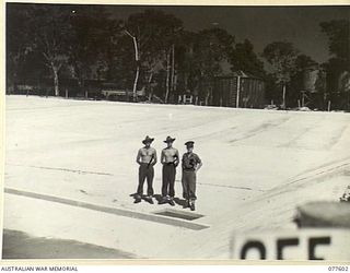 TX15215 SAPPER D.L. MILLER (1), TX14903 SAPPER L.K. JACKSON (2) AND VX1371 WARRANT OFFICER II, E.J. MCKINLEY, COMPANY SERGEANT MAJOR (3) NO. 2 PLATOON, 23RD FIELD COMPANY, EXAMINING A LARGE ..