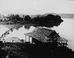 Two dwellings by the river, New Guinea, c1924 to ?