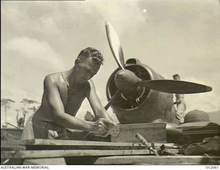 BOUGAINVILLE ISLAND, SOLOMON ISLANDS. 1945-01-12. 8841 CORPORAL L. R. WARNER OF WOODVILLE, SA, WORKING IN THE CARPENTER'S SHOP OF NO. 5 (BOOMERANG) SQUADRON RAAF AT PIVA AIRFIELD, TOROKINA, MAKING ..