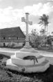Guam, dog sleeping on base of cross monument