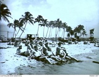 THE SOLOMON ISLANDS. AUSTRALIAN AND NEW ZEALAND AIRMEN RELAX ON THE BEACH AT BOUGAINVILLE ISLAND. (RNZAF OFFICIAL PHOTOGRAPH.)