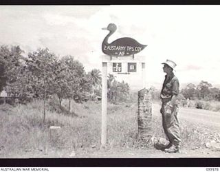 LAE, NEW GUINEA, 1945-11-20. THE SIGN AT THE ENTRANCE TO THE CAMP OF 2 ARMY TROOPS COMPANY, ROYAL AUSTRALIAN ENGINEERS. BECAUSE OF THEIR PROLONGED STAY ON THE MAINLAND, PERSONNEL OF THIS COMPANY ..