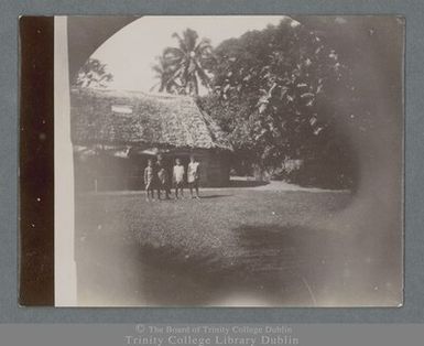 Photograph of Samoan children standing outside a traditional dwelling in Apia, Samoa