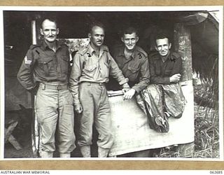 RAMU VALLEY, NEW GUINEA. 1943-12-21. ORDERLY ROOM STAFF OF HEADQUARTERS, ROYAL AUSTRALIAN ENGINEERS, 7TH AUSTRALIAN DIVISION. LEFT TO RIGHT: NX17157 CORPORAL C. GORMLY; NX35085 CAPTAIN R. J. S. ..