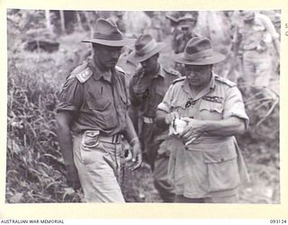 WEWAK AREA, NEW GUINEA, 1945-06-14. GENERAL SIR THOMAS A. BLAMEY, COMMANDER-IN-CHIEF, ALLIED LAND FORCES, SOUTH WEST PACIFIC AREA (3), EXAMINING ONE OF THE 4,000 URNS DISCOVERED IN A JAPANESE ..