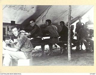 SIAR, NEW GUINEA. 1944-06-28. THE OPERATING ROOM OF THE SIGNALS OFFICE AT HEADQUARTERS, 15TH INFANTRY BRIGADE. IDENTIFIED PERSONNEL ARE:- V35506 SIGNALLER C.R. KEAM (1); VX103281 CORPORAL N.F. ..