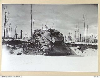 TOROKINA AREA, BOUGAINVILLE, 1945-08-06. AN M24 GENERAL CHAFFEE LIGHT TANK COMING DOWN A FIVE FOOT THREE INCH EMBANKMENT DURING TRIALS CONDUCTED FOR THE WAR OFFICE