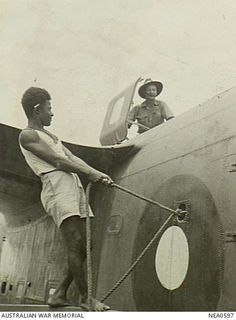 Port Moresby, New Guinea. 1944-09-23. Papuan boathand assists coxswains of RAAF launches. The native has just made fast to a Martin PBM Mariner flying boat aircraft, serial no. A70-4, of No. 41 ..