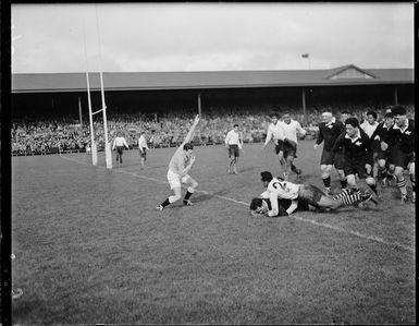 An unidentified New Zealand Maori team player scoring a try during a match with Fiji