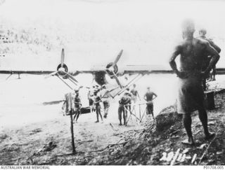 SEPIK RIVER AREA, NEW GUINEA. 1943-11-28. LIEUTENANTS H. A. J. FRYER AND GUY BLACK, MEMBERS OF M SPECIAL UNIT, SERVICES RECONNAISSANCE DEPARTMENT, ALLIED INTELLIGENCE BUREAU, PREPARE TO BOARD A ..