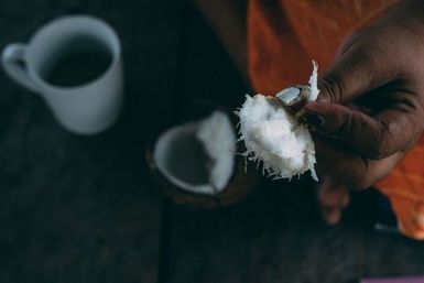 Woman holding coconut flesh, Fakaofo, Tokelau