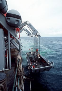 A 35-foot work boat is lowered from the port side of the salvage and rescue ship USS BRUNSWICK (ATS-3) as the ship conducts operations near Majuro Atoll. The BRUNSWICK will be in the islands for 90 days while its crew salvages a wreck that is blocking the harbor at the island of Jaluit