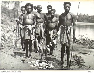 HANSA BAY, NEW GUINEA. 1944-09-06. NEW GUINEA NATIVES WITH FISH CAUGHT IN THE BOROI RIVER WHICH THEY ARE SELLING TO THE CATERERS OF HEADQUARTERS, B COMPANY, 25TH INFANTRY BATTALION