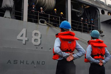 U.S. Navy line handlers from the Harpers Ferry Class Dock Landing Ship USS OAK HILL (LSD 51) stand by to assist the Whidbey Island Class Dock Landing Ship USS ASHLAND (LSD 48) for deployment from Naval Amphibious Base Little Creek on November 16, 2006. The ASHLAND will relieve Tarawa Class Amphibious Assault Ship USS SAIPAN (LHA 2) in the 5th Fleet area of responsibility. (U.S. Navy photo by Mass Communication SPECIALIST SEAMAN John Suits) (Released)