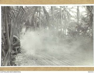 SIALUM, NEW GUINEA. 1944-01-07. JEEPS MOVING ALONG A DUSTY TRACK NORTH OF THE VILLAGE