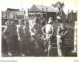 CAPE WOM, WEWAK AREA, NEW GUINEA, 20-09-1945. MEMBERS OF AN ADVANCE PARTY FROM 18 JAPANESE ARMY WAITING AT HQ 6 DIVISION AFTER ARRIVAL FROM HAYFIELD BY DOUGLAS C47 DAKOTA AIRCRAFT. THEY ARE ON ..