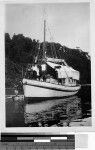 Three people on the front of a sailboat, Solomon Islands, Oceania, 1941