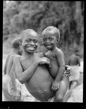 Portrait of two young Bougainville Island children by the river, North Solomon Island group