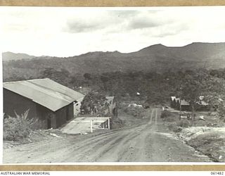 PORT MORESBY, NEW GUINEA. 1943-12-07. GENERAL VIEW OF NO. 3 SUB DEPOT, 10TH AUSTRALIAN ADVANCED ORDNANCE DEPOT SHOWING THE GENERAL ENGINEERS STORE AND BULK STORE FOR GUN BARRELS (LEFT) AND TRIPLE ..