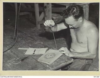 BOUGAINVILLE. 1945-04-26. SAPPER R. JOHNS, 11 FIELD COMPANY, ROYAL AUSTRALIAN ENGINEERS, WORKING ON A WRITING CASE IN THE HOBBIES SECTION OF 2/3 CONVALESCENT DEPOT