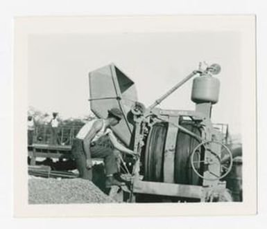 [Man Uses Cement Mixer]