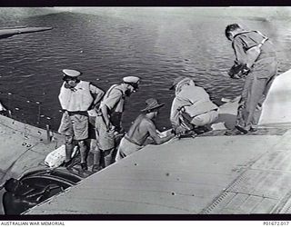 KIA PASSAGE, SANTA ISABEL ISLAND, SOLOMON ISLANDS, 1944-03. LIEUTENANT (LT) F.W. MCCONAGHY, RANVR, A MEMBER OF THE STAFF OF THE DEPUTY SUPERVISING INTELLIGENCE OFFICER (DSIO), NAVAL INTELLIGENCE ..