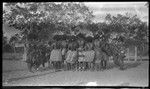 Motu people dancing, man on right plays kundu drum