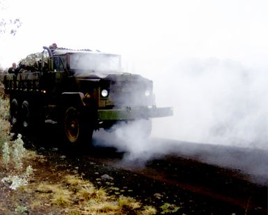 During a gas attack on Charlie Company, 1ST Batallion, 3rd Marines, in the Pohakuloa Training Area, Hawaii, US Marine Corps STAFF Sergeant Carden the Marine Air Ground Task Force Noncommissioned Officer in Charge for the NBC walks by a 5 ton vehicle and envelopes the truck. (Substandard image)