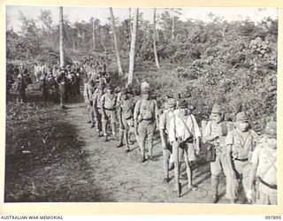 KAHILI, BOUGAINVILLE. 1945-09-30. JAPANESE TROOPS LINED UP FOR CHECKING BEFORE BEING TRANSPORTED TO THE CONCENTRATION AREA ON FAURO ISLAND. THE SURRENDER COMMISSION FROM HEADQUARTERS 2 CORPS IS ..
