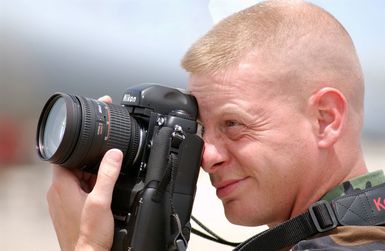 US Marine Corps (USMC) STAFF Sergeant (SSGT) Michael Picklo, Combat Photographer, Marine Corps Air Station (MCAS) Yuma, Arizona (AZ), documents aircraft operations on the flightline at Andersen Air Force Base (AFB), Guam, during Exercise TANDEM THRUST 2003, a joint military endeavor including forces from the United States, Canada and Australia