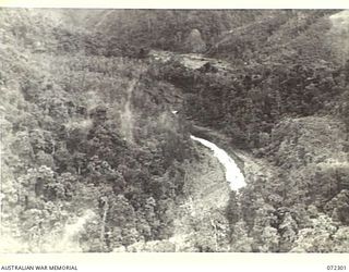 YAULA, NEW GUINEA. 1944-04-11. THE VIEW ALONG MINDJIM VALLEY. IT IS TYPICAL OF THE TERRAIN IN WHICH THE JAPANESE ESTABLISHED AMBUSHES WHICH WERE OVERCOME BY THE ADVANCING 57/60TH INFANTRY BATTALION