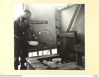 ORO BAY, NEW GUINEA. 1943-07. A DEMONSTRATION OF THE SYSTEM OF EMPTYING AND DISINFECTING PANS AND BOTTLES IN THE LATRINE OF THE 10TH FIELD AMBULANCE