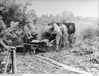 FINSCHHAFEN, NEW GUINEA. 1943-09-23. MEN OF "F" TROOP, 62ND BATTERY, 2/12TH AUSTRALIAN FIELD REGIMENT, USING A 25-POUNDER GUN TO SHELL THE KAKAKOG AREA FROM THE AIRSTRIP. LEFT TO RIGHT:- VX22646 ..