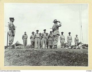 PORT MORESBY, NEW GUINEA. 1944-08-05. VX44 COLONEL T.P. COOK CBE ED, COMMANDING, MORESBY BASE SUB AREA, LAYING HIS WREATH DURING THE OFFICIAL OPENING CEREMONY OF THE BOMANA WAR CEMETERY. THE ..