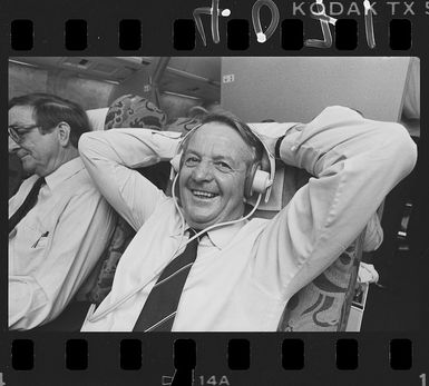 New Zealand's Ambassador to the United States of America, Sir Wallace Rowling, on board an airplane - Photograph taken by Greg King