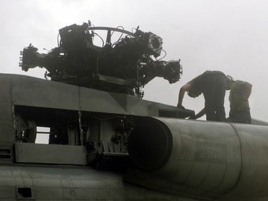 Lance Corporal Drue N. McIver and Corporal Kenny Carlyle, from HMH-463 Kaneohe Bay Hawaii, put a CH-53E Super Stallion helicopter that was disassembled so it could be transported to Anderson Air Force Base, Guam, back together as part of Exercise KOA THUNDER 2001 at Anderson Air Force Base. Marines from Aviation Support Element, Kaneohe Bay Hawaii, 1ST Marine Air Wing, Okinawa, Japan, and 3rd Marines 7th Battalion 29 Palms, California, participated in KOA THUNDER on the island of Guam from July 9 to July 14. The purpose of the exercise was to demonstrate the Marine Corps' ability to deploy in the South Pacific from places other than Okinawa, Japan