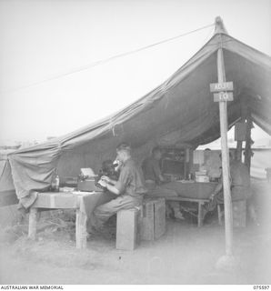 MARKHAM VALLEY, NEW GUINEA. 1944-08-28. CLERKS AT WORK IN THE ORDERLY ROOM OF THE 4TH FIELD REGIMENT. IDENTIFIED PERSONNEL ARE: VX149701 BOMBARDIER C.D. CLARKE (1); SX1591 WARRANT OFFICER I, J.H. ..