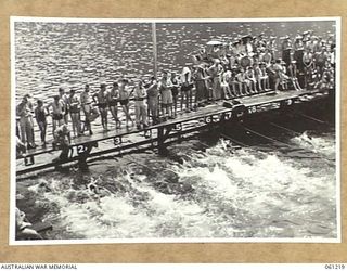 PORT MORESBY, NEW GUINEA. 1943-11-28. FINISH OF THE 100 YARDS FREESTYLE FINAL AT THE ALLIED SERVICES GRAND SWIMMING CARNIVAL