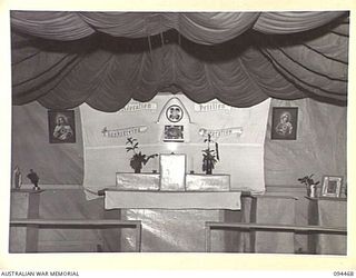 LAE AREA, NEW GUINEA. 1945-08-03. THE ALTAR IN THE SANCTUARY OF THE BUSU ROAD ROMAN CATHOLIC CHAPEL. USE HAS BEEN MADE OF SISALCRAFT AND A PARACHUTE IN ITS CONSTRUCTION