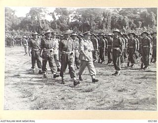 TOROKINA, BOUGAINVILLE. 1945-05-18. LIEUTENANT GENERAL S.G. SAVIGE, GENERAL OFFICER COMMANDING 2 CORPS (6), ACCOMPANIED BY LIEUTENANT J. CHESTERTON (4), AND SENIOR OFFICERS DURING AN INSPECTION OF ..
