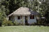 French Polynesia, thatched-roofed cottage on Tahiti Island