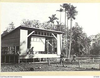 LAE, NEW GUINEA. 1944-06-02. THE STAGE AND SCREEN AT HEADQUARTERS NEW GUINEA FORCE NEARING COMPLETION. PICTURES ARE NOW SHOWN AT THIS SITE TWICE WEEKLY. THE THEATRE IS SITUATED ON THE SITE OF A ..