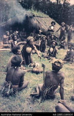 Small group of men with a wrapped bundle