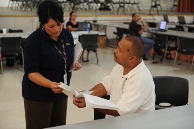 Earthquake ^ Tsunami - Utulei, American Samoa, October 8, 2009 -- FEMA Disaster Recovery Center Manager, Gabriela Garibaldi, explains funeral reimbursement process to an applicant. FEMA Individual and Households Program may provide assistance with funeral costs that are directly related to the disaster. David Gonzalez/FEMA